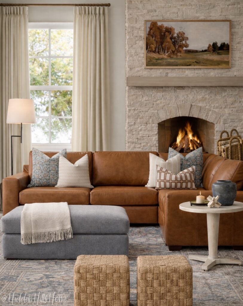 Warm neutral living room with leather sectional, stone fireplace, and layered textures
